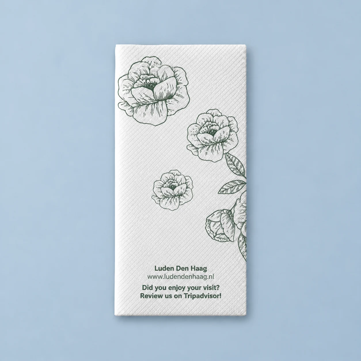 Luden Den Haag · Airlaid napkin · back · Flowers and an invitation to leave a review
